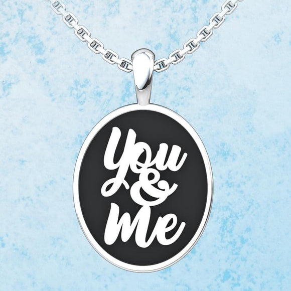 You & Me Sterling Silver Pendant on a blue background