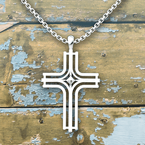Radiant Cross Sterling Silver Necklace on an 18 inch chain with an old wood background
