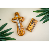 inri crucifix cross and detached base laid flat among palm fronds