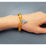 Olive Wood Stretch Bracelet, Gold Beads and Cross/Dove Dangle on female wrist