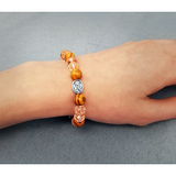 Olive Wood Stretch Bracelet, Pink Beads and Jerusalem Cross, Virgin Mary on female wrist