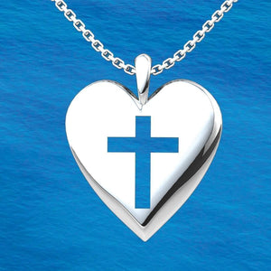 Simple Heart Cross Sterling Silver Pendant with 18 inch chain with an ocean background