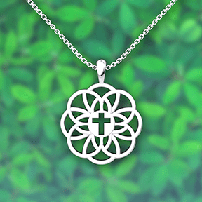 Flourish Cross Sterling Silver Necklace with 18 inch chain and plant background 