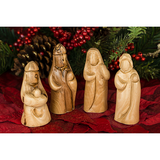 The olive wood nativity pieces representing the shepherds and maidens at Jesus' birth