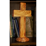 12" Olive Wood Standing Cross placed on a bookshelf