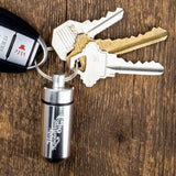 Oil Vial Keyring showing keyring vial holder with keys on wood background