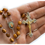 Olive Wood Rosary with Immaculate Heart of the Virgin Mary Oval Medal close view in hand