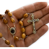 Olive Wood Rosary with Virgin Mary and Jesus Silver Oval Medal and Jerusalem Soil back view in hand