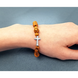 Olive Wood Stretch Bracelet, Beads and Inlet Cross on female wrist