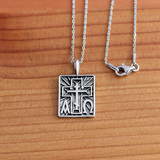 Alpha Omega & St Andrew Cross Sterling Silver Pendant - 18 Inch Chain on a wooden table