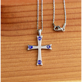 Mount Sinai Cross Sterling Silver Pendant -  18 Inch Chain on a wooden table